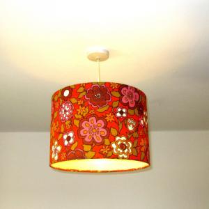 Lampshade dressed in 70's orange flower patterned fabric flowerpower style