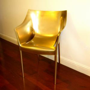 Redesign in gold of Philippe Starck's Dr. No chair from the Kartell collection